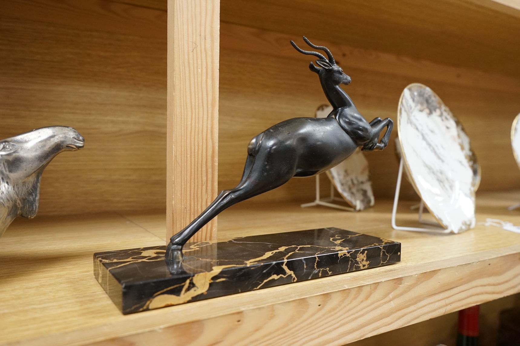 An Art Deco spelter study of a leaping gazelle, 27cm wide